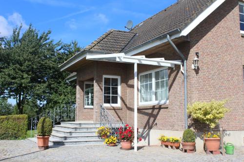 a brick house with a white pergola at Steenshof in Klötzin