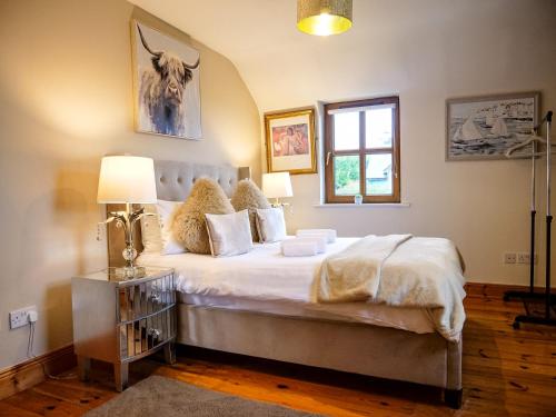 a bedroom with a large bed and a window at Dingle View - 37 Tír Na Fiuise in Dingle