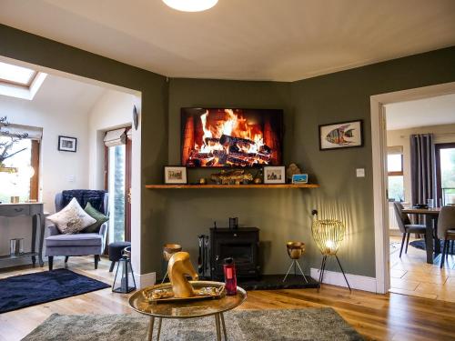 a living room with a fire on the wall at Dingle View - 37 Tír Na Fiuise in Dingle