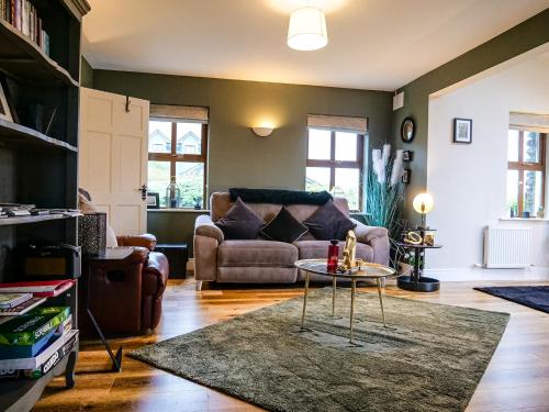 a living room with a couch and a table at Dingle View - 37 Tír Na Fiuise in Dingle