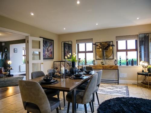 a dining room with a table and chairs at Dingle View - 37 Tír Na Fiuise in Dingle