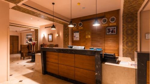 a kitchen with wooden cabinets and a counter at Club Paradisio in Marrakesh