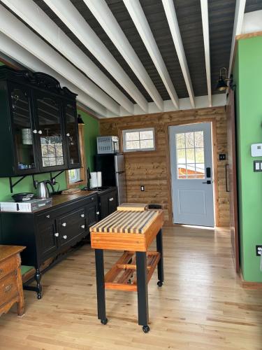 a kitchen with a table in the middle of a room at Cupids Guest House and SheShed in Brigus
