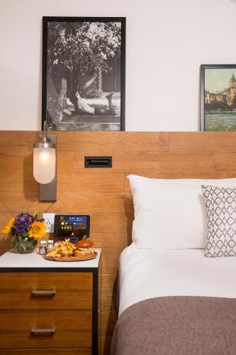 a bedroom with a bed and a table with a plate of food at AT&T Hotel & Conference Center in Austin
