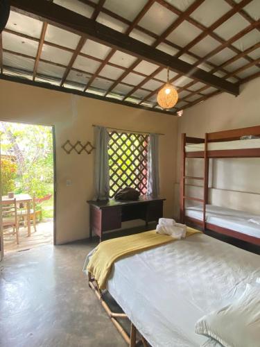 a bedroom with a large bed and a window at Hostel do Ceu in Pipa