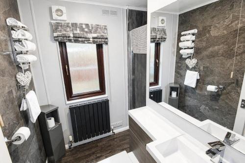a bathroom with a sink and a shower at Grasmere 12, White Cross Bay, Windermere in Troutbeck Bridge