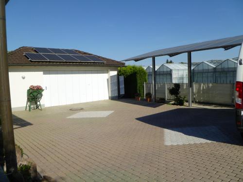 a patio with a roof with solar panels on it at Villa XADAYU, Appartment in Reichenau
