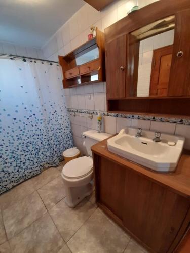 a bathroom with a toilet and a sink at Tongoy península in Coquimbo