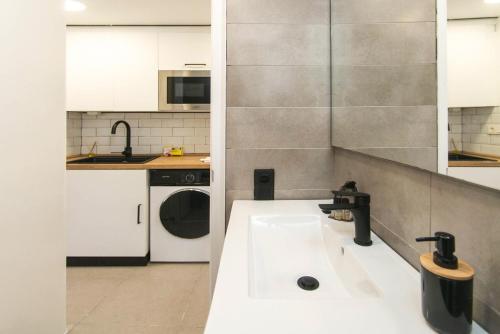 a kitchen with a sink and a washer and dryer at WELCS APARTAMENTO 342 PDA con terraza in Platja d'Aro
