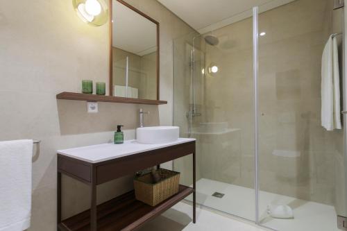 a bathroom with a sink and a shower at Casa Falcão Boutique Hotel by Aspasios in Porto