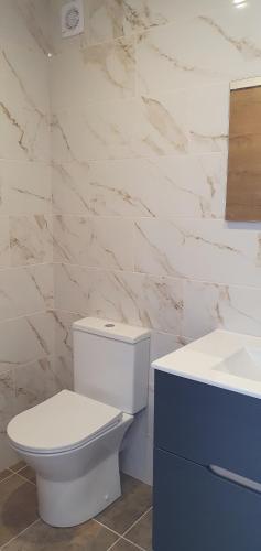 a bathroom with a white toilet and a sink at Penthouse with panoramic view in Vilamoura