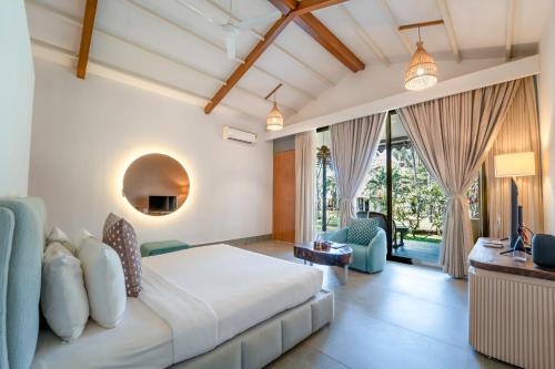 a bedroom with a bed and a living room at Marbela Beach Resort in Morjim
