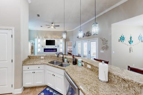 a kitchen with a sink and a counter top at 2 Mi to Beach! Group-Friendly Navarre Getaway in Navarre