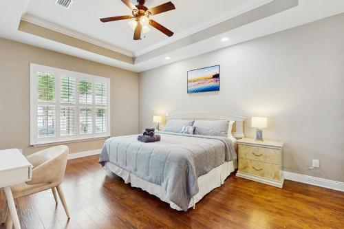 a bedroom with a bed and a ceiling fan at 2 Mi to Beach! Group-Friendly Navarre Getaway in Navarre