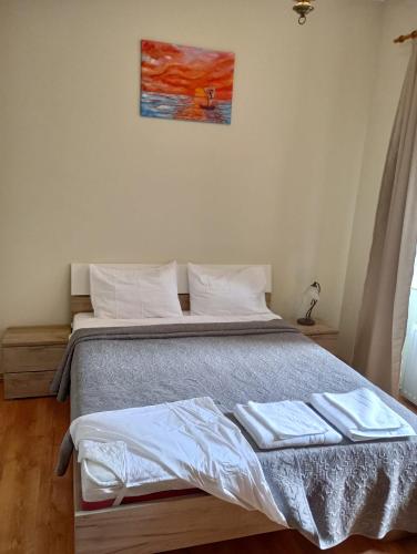 a bedroom with a bed with two towels on it at BLISS HOUSE UNIRII in Oradea