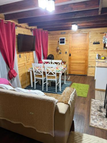 a living room with a couch and a table at Cabaña de campo in Castro
