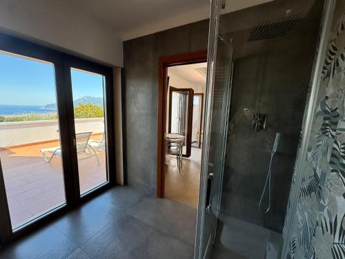 a bathroom with a shower and a view of a patio at Villa Setharè in Salerno