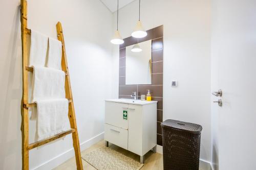 a bathroom with a sink and a towel rack at Casa Da Avo Clementina in Funchal