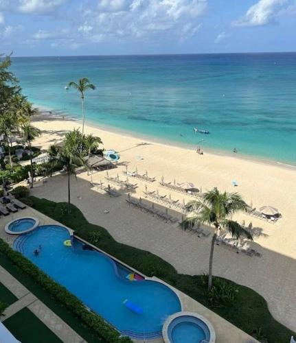a view of the beach from the balcony of a resort at Apartment with Exclusive Amenities in George Town