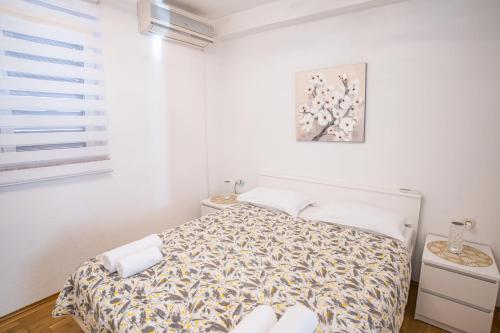 a bedroom with a bed in a white room at MA-LO 1 in Pirovac