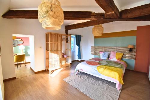 a bedroom with a large bed and a table at Château de Ravenel in Ravenel