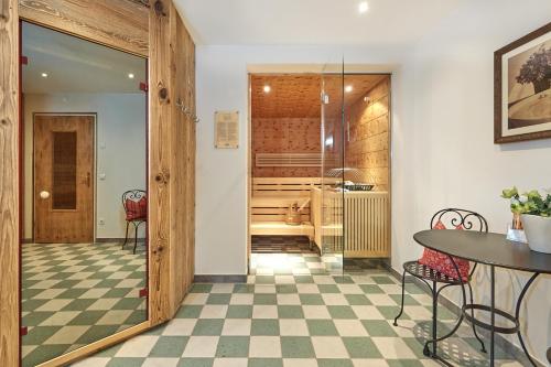 a room with a table and chairs and a wine cellar at Hotel Sonnenhügel, inklusive SommerCard in Filzmoos