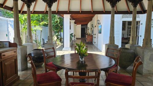 a dining room with a wooden table and chairs at Nora Lyn - Colombo in Colombo