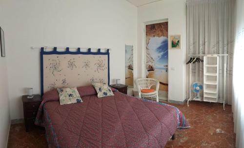 a bedroom with a bed with a red comforter at Venti In Costa in Furore