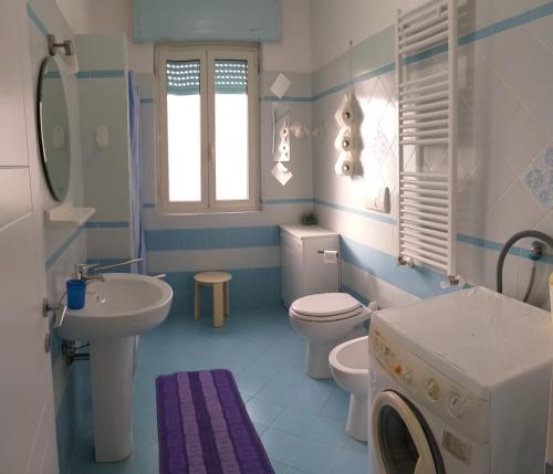 a blue and white bathroom with a sink and a toilet at Venti In Costa in Furore