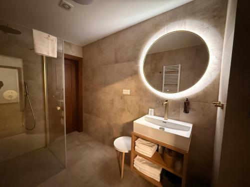 a bathroom with a sink and a mirror at Hotel International in Tatranská Lomnica