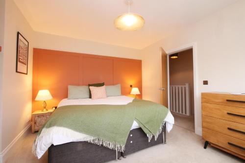 a bedroom with a large bed and a dresser at The Wheatley in Denton