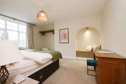a bedroom with a bed and a desk and a window at The Wheatley in Denton