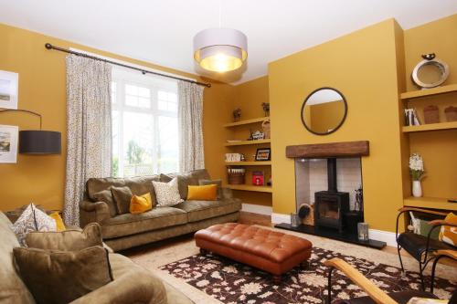 a living room with a couch and a fireplace at The Wheatley in Denton