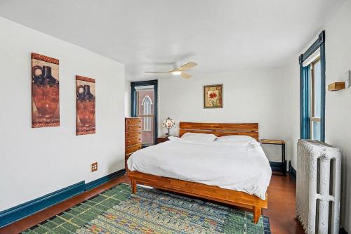 a bedroom with a large bed and a window at Lil' Red House On Porter in Detroit
