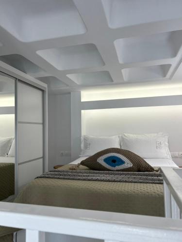a bedroom with a bed and a mirror at G A Suites Maisonettes in Skala in Skala