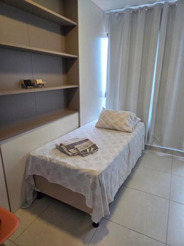 a small room with a bed and a window at Apartamento Fantástico - com estação para carros eletricos in Campina Grande
