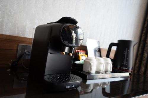 a coffee maker sitting on top of a table at London Court Hotel in London