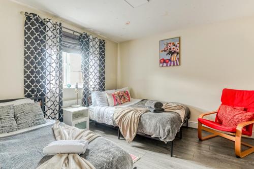 a small room with a bed and a chair at 4BD Spacious detached House in Birmingham suitable for Contractors and family's with free parking on private drive sleeps 9 in Birmingham