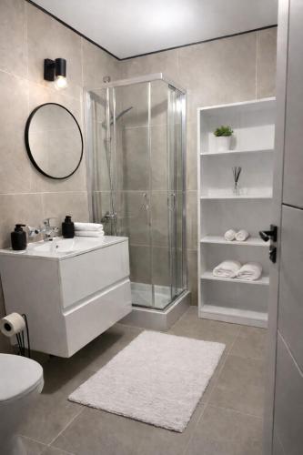 a bathroom with a shower and a sink and a toilet at Całoroczny Domek Chill in Sława