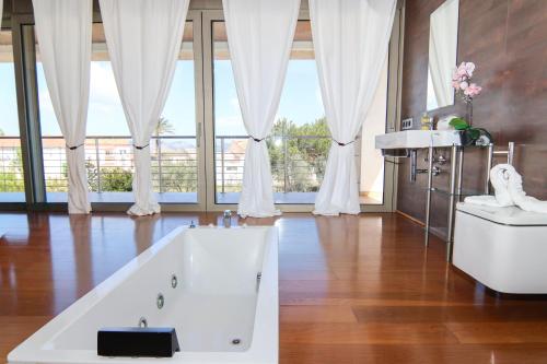a large bathroom with a tub and a sink at 206 Villa Isabel ET2341 by Mallorca Charme in Alcudia