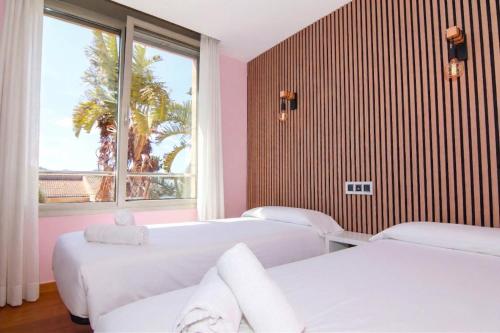 a hospital room with three beds and a window at 206 Villa Isabel ET2341 by Mallorca Charme in Alcudia