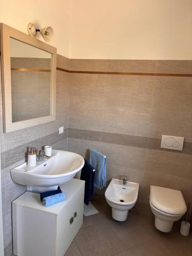 a bathroom with a sink and a toilet at Casa Angela in Olbia