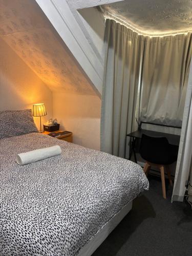 a bedroom with a bed and a chair and a desk at MC Suites in Old Walker
