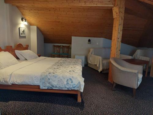 a bedroom with a bed and chairs in a room at Family Hotel St Stefan Nessebar in Nesebar