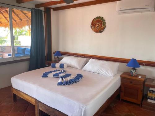 a bedroom with a bed with blue and white dishes on it at Penthouse Bella Vista in Puerto Escondido