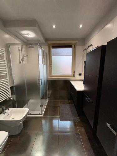 a bathroom with a shower and a sink and a toilet at La casa nel parco in Chieri