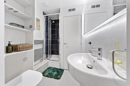 a white bathroom with a sink and a toilet at Tranquil 2B Japandi-Inspired Apt 2 min from St Paul's in London