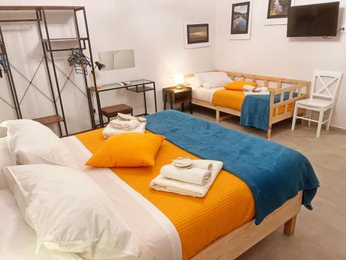 a bedroom with two beds with towels on them at Basso 61 Urban Oasis with Private Mini Pool & Courtyard - Families & Groups in Palermo