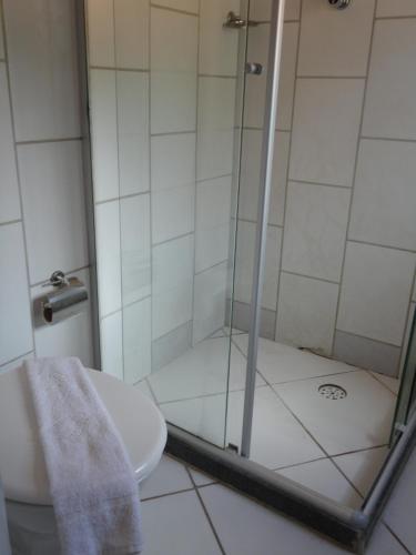 a bathroom with a shower and a toilet at Pousada Suítes Do Pelô in Salvador
