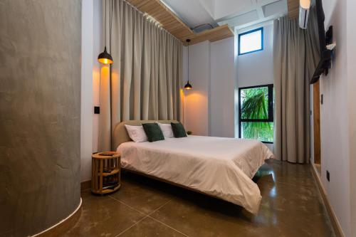 a bedroom with a bed and a window at Hotel Boutique Obelisco in Medellín